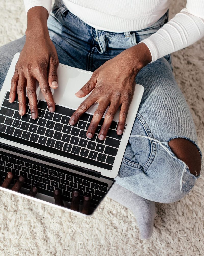 Hands typing on a laptop